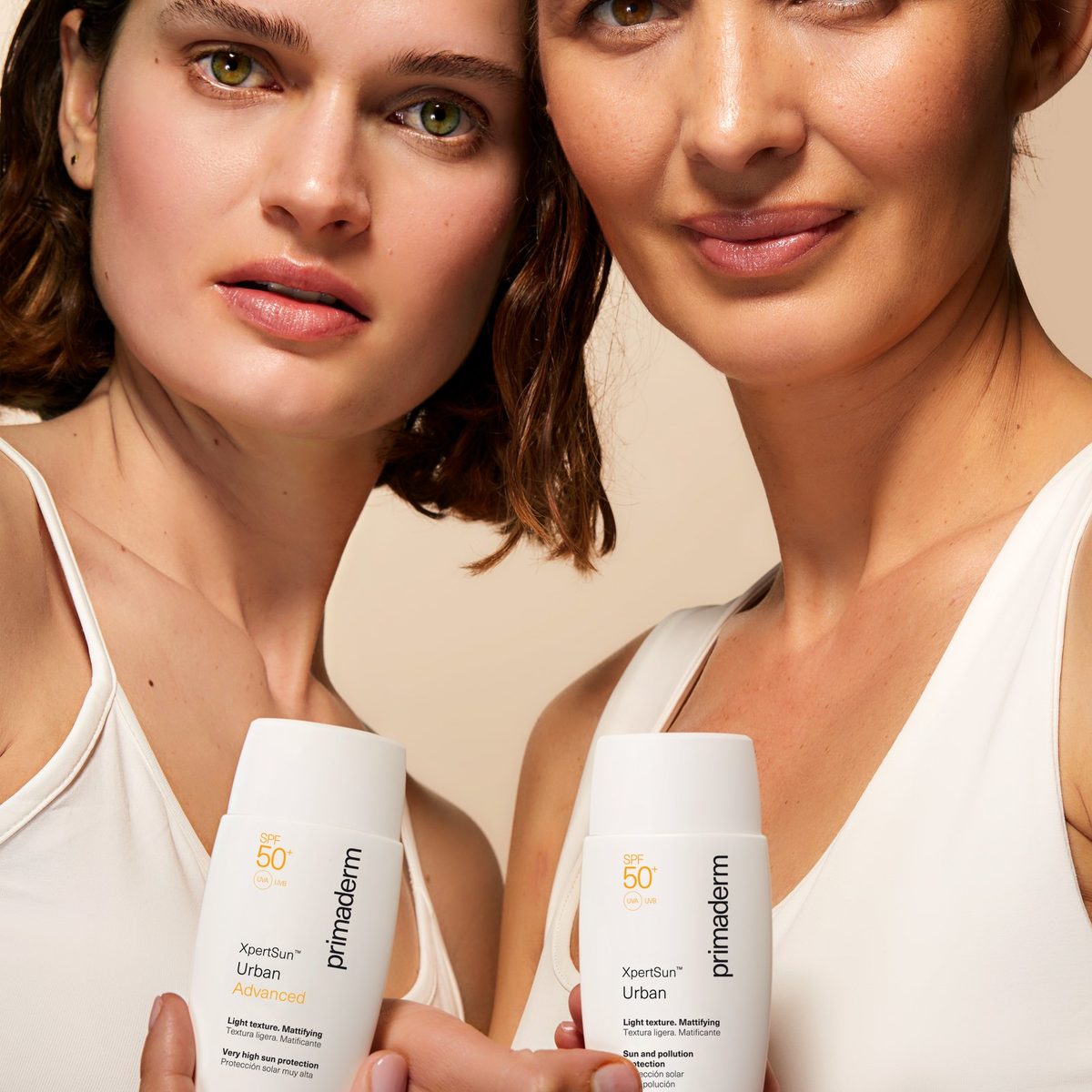 Two women holding XpertSun Urban sunscreens